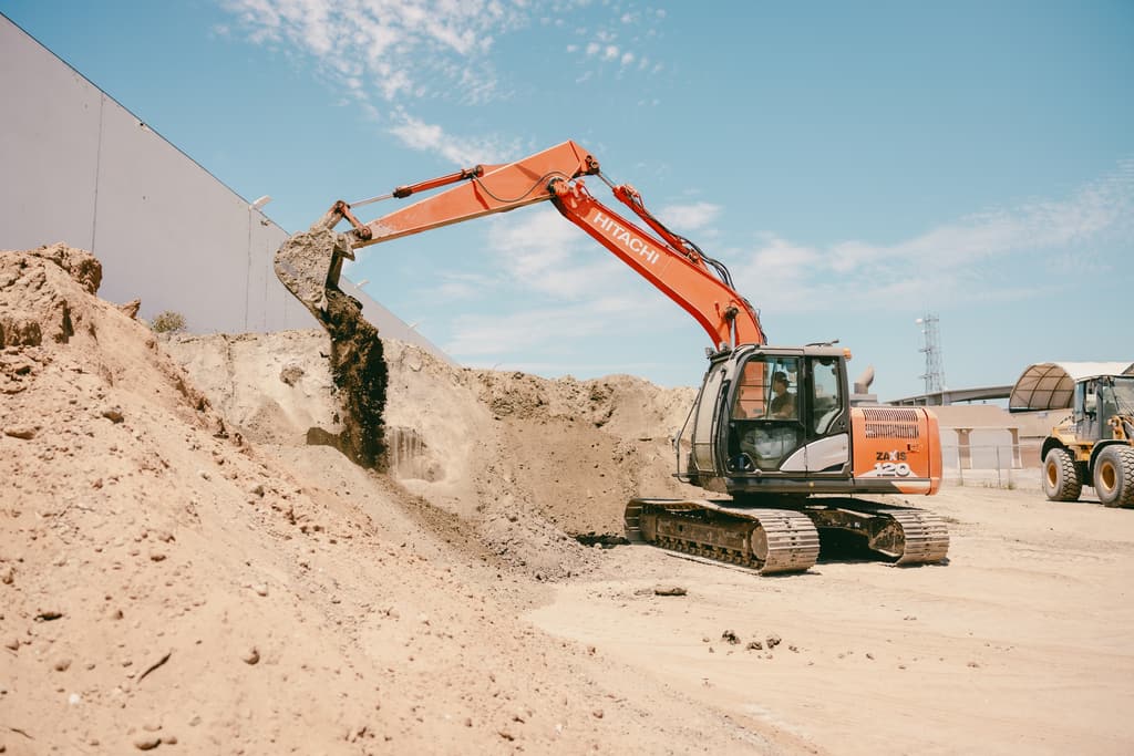 Excavator digging into the face of the stockpile