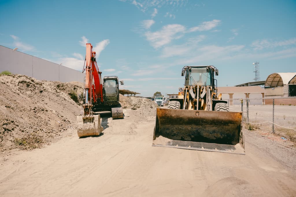 Excavator and wheel loader staged on the yard road